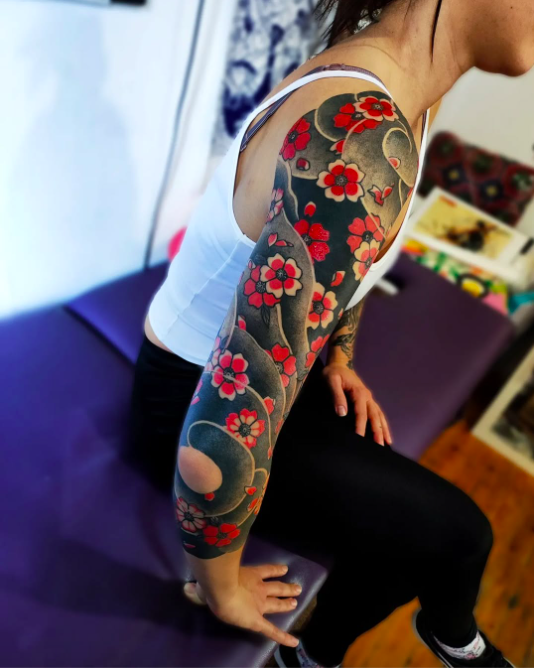 Blossom Storm A Bold Japanese Sleeve Tattoo for Women