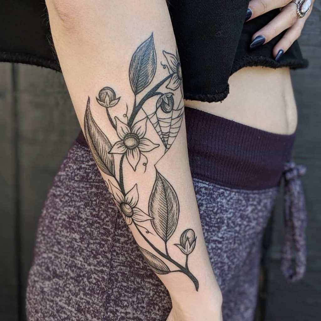 The Poison Weaver witchy flower tattoo